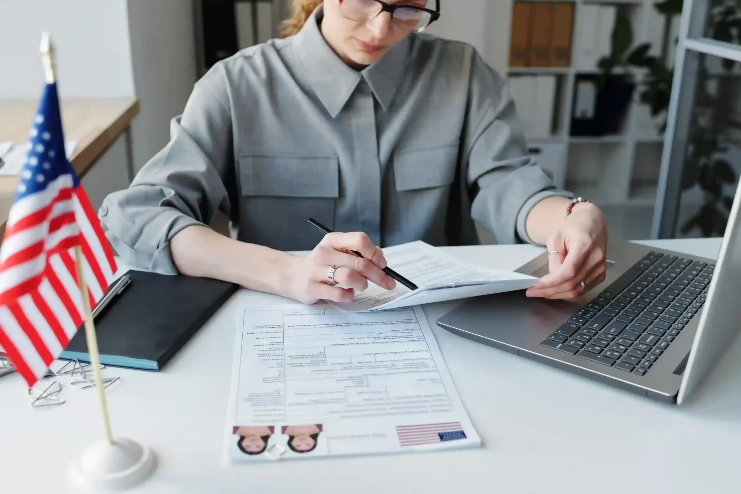 high-angle-shot-mature-caucasian-woman-wearing-grau-shirt-sitting-desk-office-working-with_11zon